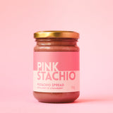 Jar of Pinkstachio spread against a pink background