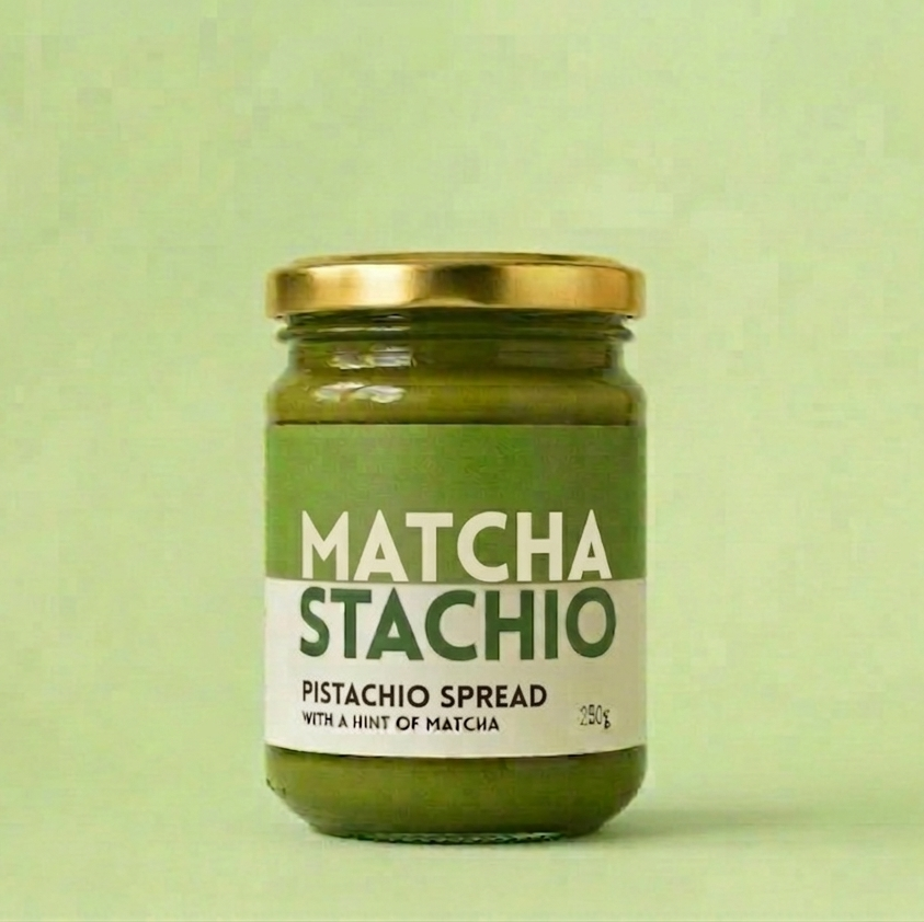 Jar of Matcha Stachio pistachio spread on a green background