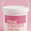 White container of Pink Stachio pistachio spread with a pink label on a pink background